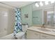 Bathroom with tub and shower featuring colorful shower curtain and vanity at 1226 Siesta Bayside Dr # 1226C, Sarasota, FL 34242