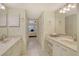 Dual vanity bathroom with tile flooring and adjacent bedroom access at 1226 Siesta Bayside Dr # 1226C, Sarasota, FL 34242