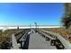 Boardwalk path leading to the sandy beach, providing easy access for residents and visitors to enjoy the coast at 1226 Siesta Bayside Dr # 1226C, Sarasota, FL 34242
