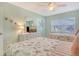 Bedroom featuring two beds with matching seashell bedding and a large window at 1226 Siesta Bayside Dr # 1226C, Sarasota, FL 34242