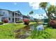 Community pond with landscaping and a view of condo buildings at 1226 Siesta Bayside Dr # 1226C, Sarasota, FL 34242