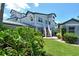 Beautiful two-story condo building with lush greenery, a well-manicured lawn, and white stairs leading to the entrance at 1226 Siesta Bayside Dr # 1226C, Sarasota, FL 34242