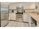 Well-equipped kitchen featuring stainless steel appliances, white cabinets, and tile backsplash at 1226 Siesta Bayside Dr # 1226C, Sarasota, FL 34242