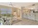 Comfortable living room featuring a ceiling fan, plush sofa, and a view into the kitchen and dining area at 1226 Siesta Bayside Dr # 1226C, Sarasota, FL 34242