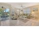 Bright and airy living room features tiled floors, comfortable seating and sliding glass doors to the screened lanai at 1226 Siesta Bayside Dr # 1226C, Sarasota, FL 34242