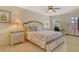 Comfortable main bedroom with a ceiling fan, side tables, and ample natural light from the window at 1226 Siesta Bayside Dr # 1226C, Sarasota, FL 34242