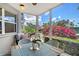 Covered and screened patio offers a relaxing view of lush landscaping, tennis courts, and community at 1226 Siesta Bayside Dr # 1226C, Sarasota, FL 34242