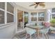Screened-in patio featuring a dining set, ceiling fan, and seamless transition to the indoor living space at 1226 Siesta Bayside Dr # 1226C, Sarasota, FL 34242