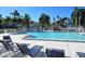 Relaxing poolside view with lounge chairs around the community pool under clear blue skies at 1226 Siesta Bayside Dr # 1226C, Sarasota, FL 34242