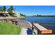 Picturesque waterfront dock with seating and table, offering a relaxing spot to enjoy the tranquil water views at 1226 Siesta Bayside Dr # 1226C, Sarasota, FL 34242