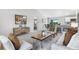 Inviting living room with neutral tones, stylish furniture, and seamless flow to the kitchen and dining area at 133 Camillia Ln, Port Charlotte, FL 33954