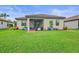 Expansive backyard with lush green lawn and screened-in patio for outdoor entertaining at 148 Wandering Wetlands Cir, Bradenton, FL 34212