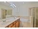 Spacious bathroom with double vanity, soaking tub, and tiled shower at 148 Wandering Wetlands Cir, Bradenton, FL 34212