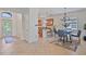 Bright dining area featuring modern chandelier, tile floors and kitchen bar access at 148 Wandering Wetlands Cir, Bradenton, FL 34212
