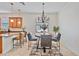 Eat-in kitchen dining area with chandelier, breakfast bar, and backyard view at 148 Wandering Wetlands Cir, Bradenton, FL 34212