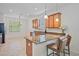 Bright kitchen with tile floors, granite counters, and stainless steel appliances at 148 Wandering Wetlands Cir, Bradenton, FL 34212