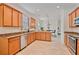 Bright kitchen with granite countertops, tile floor, and stainless steel dishwasher at 148 Wandering Wetlands Cir, Bradenton, FL 34212