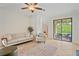 Comfortable living room with neutral palette, ceiling fan and patio access at 148 Wandering Wetlands Cir, Bradenton, FL 34212