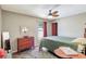 Comfortable bedroom with a decorative ceiling fan, wood dresser, and unique floor rug at 1489 18Th St, Sarasota, FL 34234