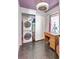 This laundry room features a stacked washer and dryer, storage, and a vintage desk area at 1489 18Th St, Sarasota, FL 34234