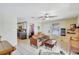 Bright living room with tile flooring, modern ceiling fan, and updated kitchen in background at 1489 18Th St, Sarasota, FL 34234