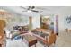 Inviting living room featuring stylish leather sofa, unique world map accent wall, and modern ceiling fan at 1489 18Th St, Sarasota, FL 34234