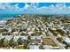 Expansive aerial view showcasing a lovely coastal home nestled within a vibrant community near a pristine beach at 215 65Th St, Holmes Beach, FL 34217