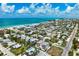 Stunning aerial view of the coastal community, highlighting the house's prime location near the beach and the inviting swimming pool at 215 65Th St, Holmes Beach, FL 34217