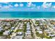 Stunning aerial view of a charming coastal home in a beautiful community, offering a glimpse of the nearby beach at 215 65Th St, Holmes Beach, FL 34217