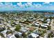Beautiful aerial shot of a cozy home with a private pool and a lush yard, surrounded by a charming neighborhood at 215 65Th St, Holmes Beach, FL 34217