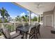 Covered balcony with a seating area, ceiling fan, and a view of lush landscaping at 215 65Th St, Holmes Beach, FL 34217