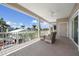 Relaxing covered balcony with comfortable seating and panoramic views of the neighborhood at 215 65Th St, Holmes Beach, FL 34217