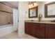 A bathroom features double vanity, granite countertops, a decorative mirror and shower at 215 65Th St, Holmes Beach, FL 34217