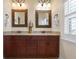 A bathroom features double vanity, granite countertops and a decorative mirror at 215 65Th St, Holmes Beach, FL 34217