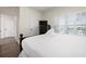 This bedroom features a queen-sized bed, wood floors, a ceiling fan, and a window with shutters at 215 65Th St, Holmes Beach, FL 34217