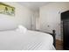 This bedroom features a queen-sized bed, wood floors, and a window with shutters at 215 65Th St, Holmes Beach, FL 34217