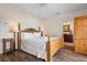 A well-lit bedroom features a wooden bed frame, wood floors and an ensuite bathroom at 215 65Th St, Holmes Beach, FL 34217