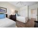 A bedroom featuring two twin beds, wood floors, a ceiling fan, and a window with shutters at 215 65Th St, Holmes Beach, FL 34217