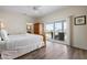 Bright bedroom with a king bed, wood floors, and sliding doors to an outdoor patio at 215 65Th St, Holmes Beach, FL 34217