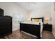 This bedroom features a queen-sized bed, wood floors, a ceiling fan, and a window with shutters at 215 65Th St, Holmes Beach, FL 34217