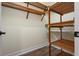 Walk-in closet with wood shelving and a hanging rod for storage at 215 65Th St, Holmes Beach, FL 34217