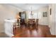Bright dining room with wood floors, a decorative chandelier, and seating for six at 215 65Th St, Holmes Beach, FL 34217