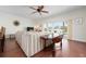 A comfortable living room with a ceiling fan, sliding glass doors to a balcony, and a striped sofa at 215 65Th St, Holmes Beach, FL 34217