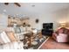 Comfortable living room with a striped sofa, area rug, and an adjacent kitchen space at 215 65Th St, Holmes Beach, FL 34217