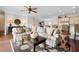 Well-lit living room with a plush sectional sofa, decorative rug, and open floor plan to the kitchen at 215 65Th St, Holmes Beach, FL 34217