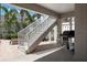 This patio area features stairs, a grill, and a sitting area in the shade at 215 65Th St, Holmes Beach, FL 34217