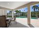 This patio features patio furniture and a view of the pool and greenery in the backyard at 215 65Th St, Holmes Beach, FL 34217