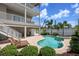 Relaxing backyard oasis with a sparkling pool, spa, and ample seating, ideal for enjoying sunny days at 215 65Th St, Holmes Beach, FL 34217