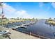 Aerial view of a dock and waterway featuring boats and residential buildings nearby at 237 Blackburn Blvd, North Port, FL 34287