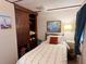 Bedroom with natural light, a storage unit, and comfortable bed at 237 Blackburn Blvd, North Port, FL 34287